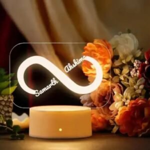 Personalized Infinity 3D Lamp Gift glowing with warm yellow light showing names Samarth and Akshima.